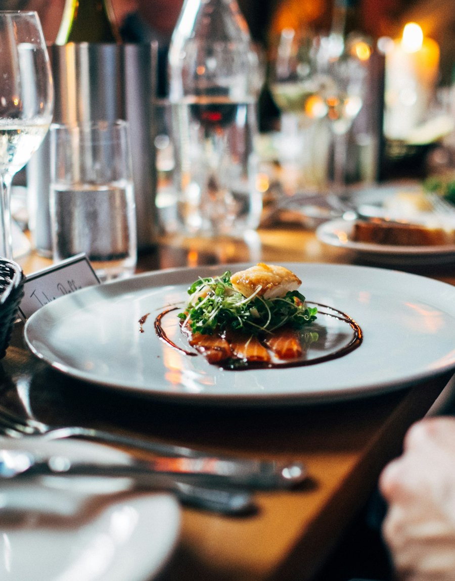 A plated dish on a candlelit table
